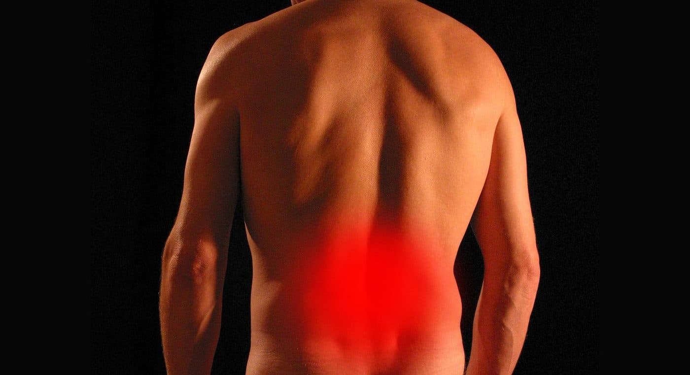 A person seen from behind with the lower back highlighted in red
