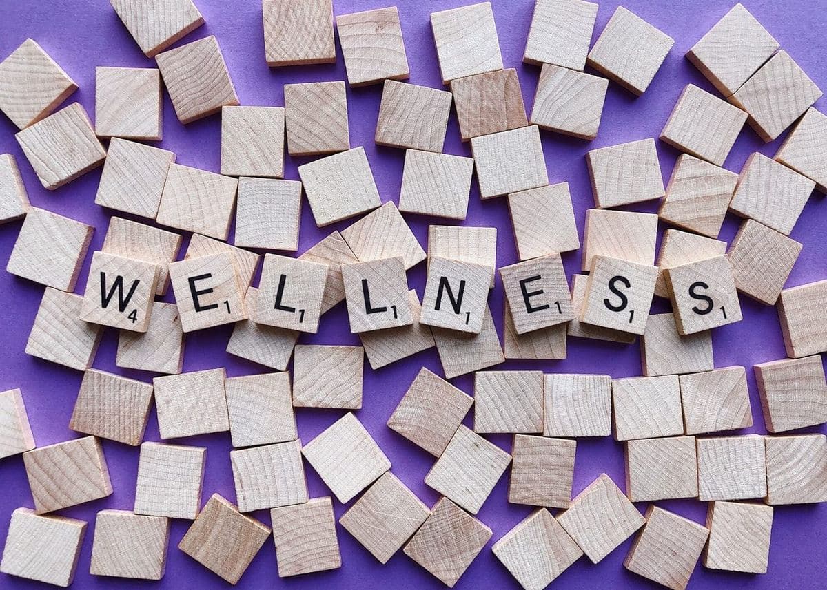 Wooden letter tiles spelling the word wellness