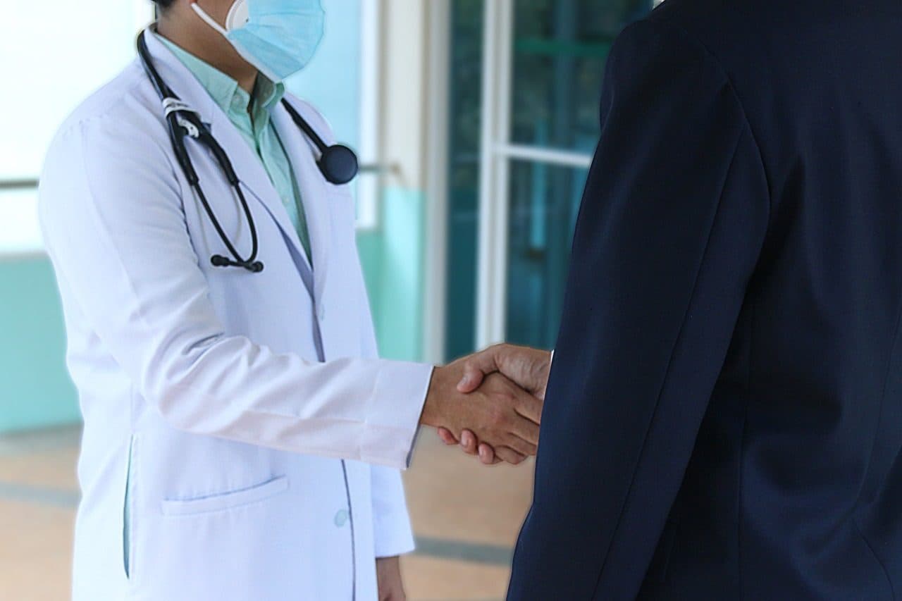 A care team member shaking hands with a patient at Guardian Primary Care