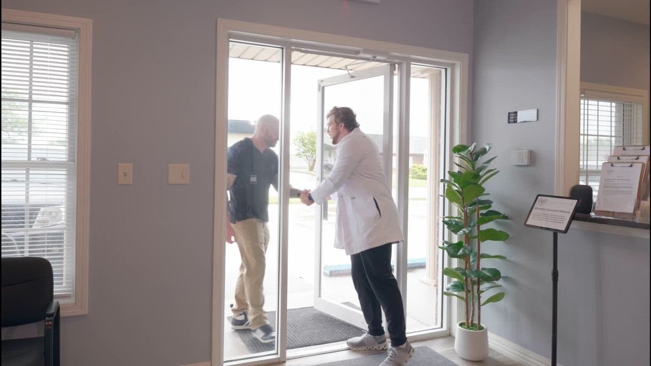 A patient being welcomed at the entrance of the Guardian Primary Care clinic in Cape Girardeau, Missouri