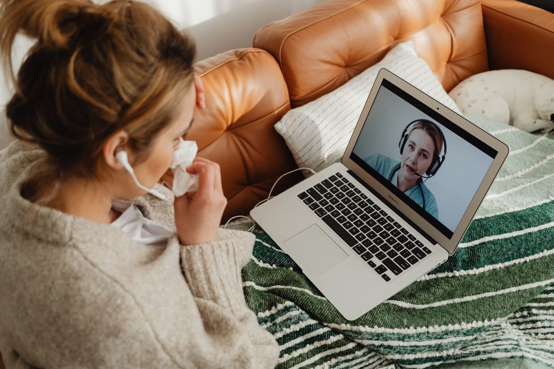 A patient having a video consultation with a clinician from home